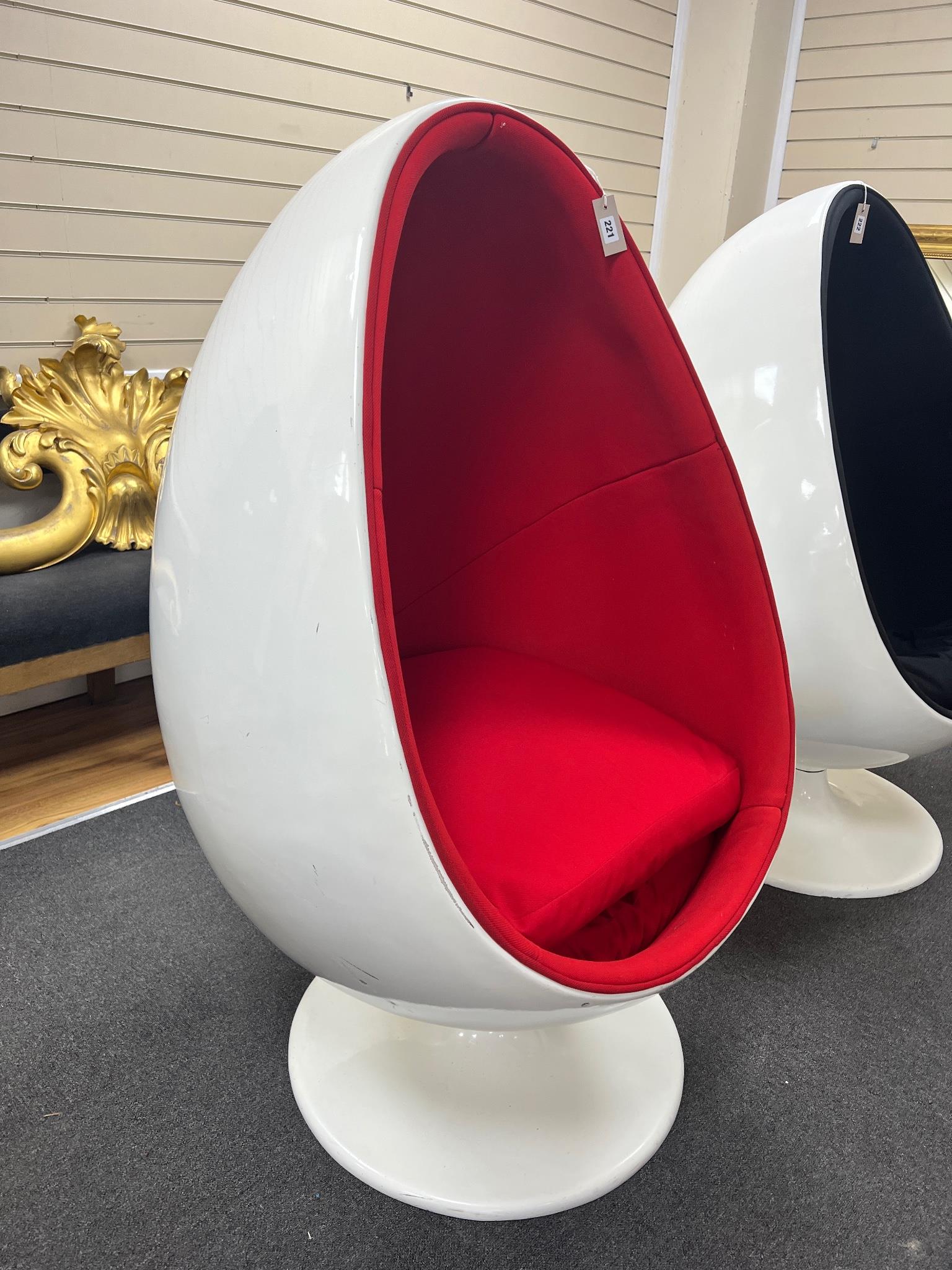 An egg pod chair, in the style of Eero Aarnio, with white plastic shell and rotating base